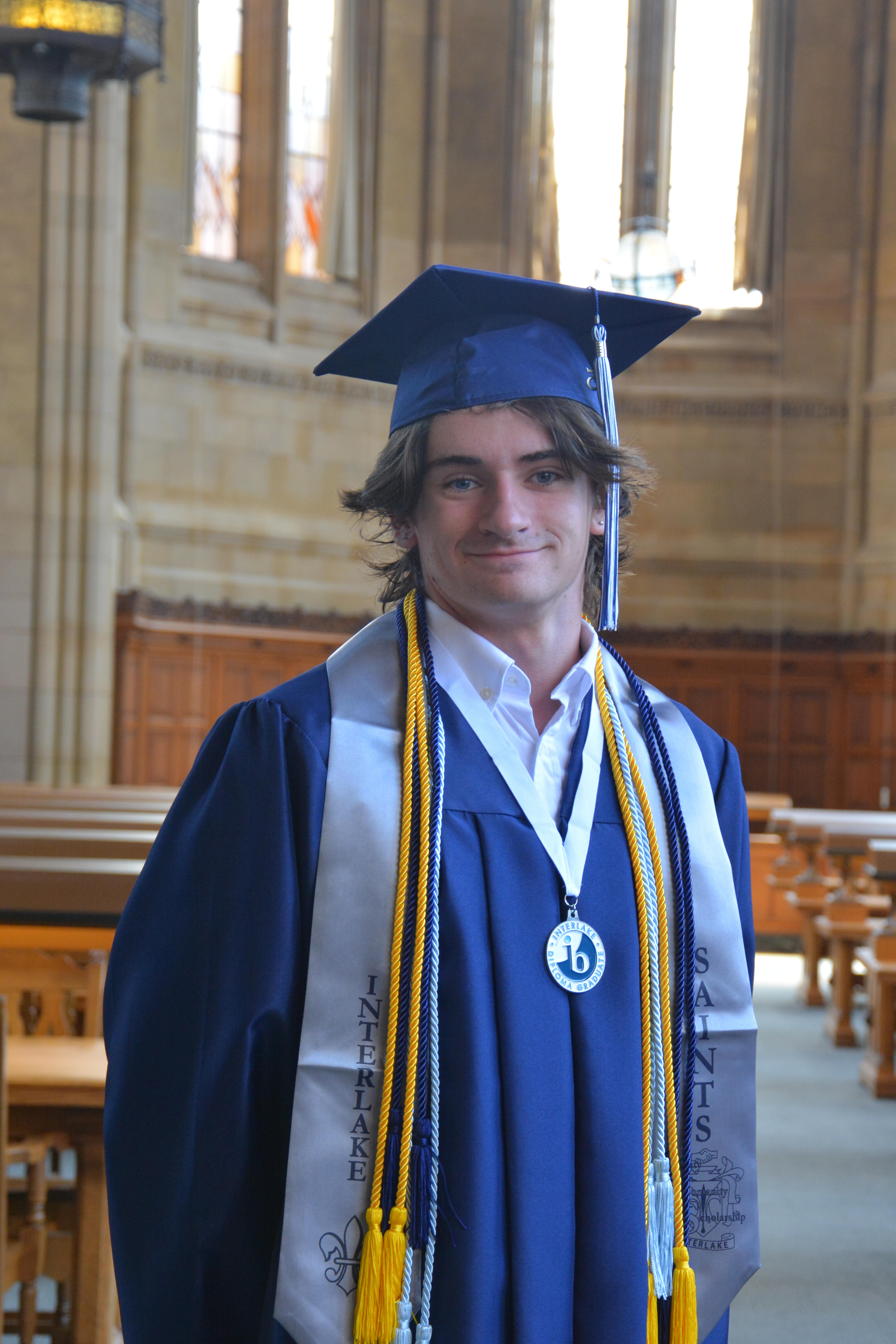 Conor Frizelle in graduation regalia at Suzzallo Library